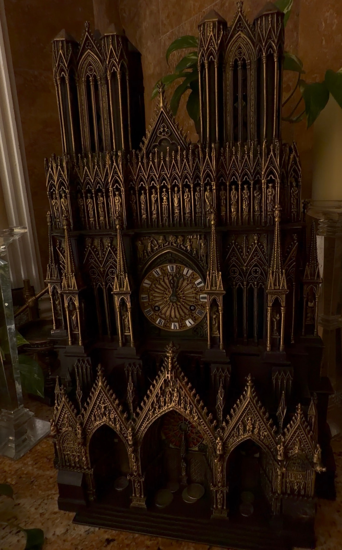 Antique gothic cathedral clock with ornate carved spires at Universal Sanctuary Church