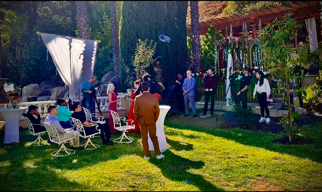 Film crew and cast filming a wedding scene on the garden lawn at Universal Sanctuary Church