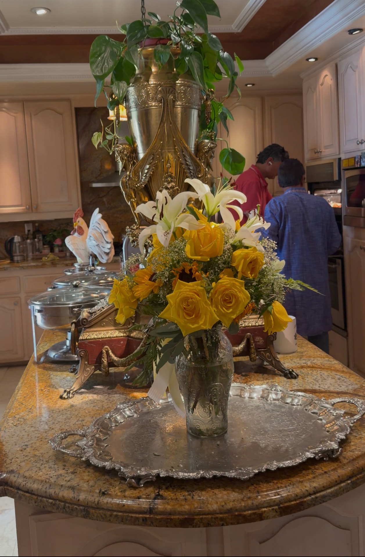 Catering island with fresh lilies and yellow roses at a Universal Sanctuary Church event