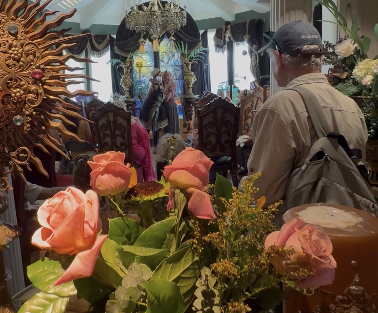 Congregation gathered for fellowship among fresh roses at Universal Sanctuary Church