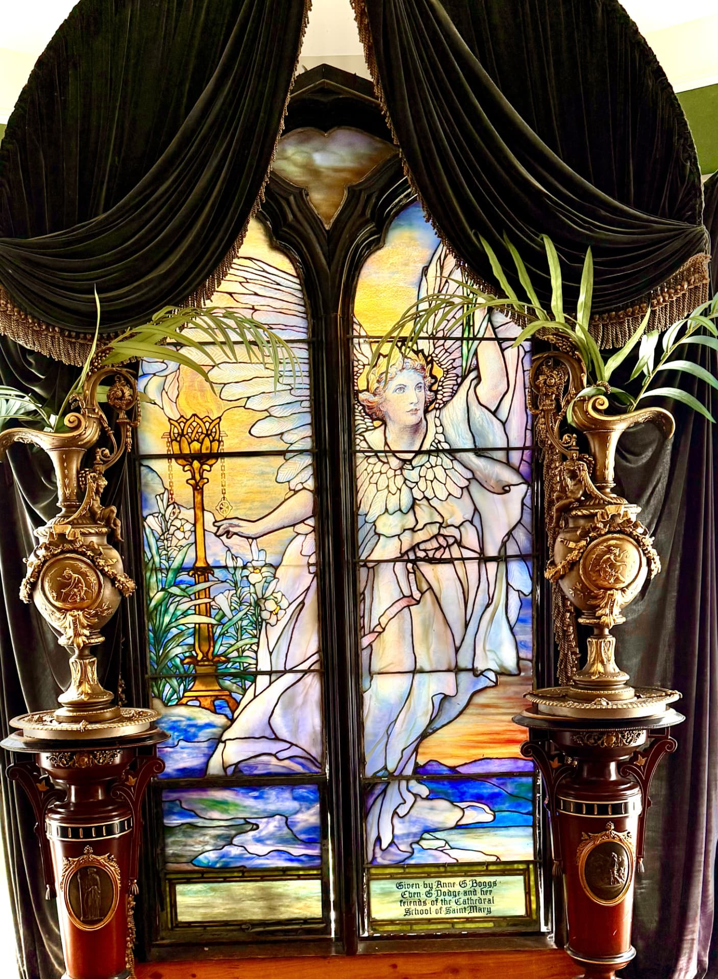 Historic stained-glass angel window displayed inside Universal Sanctuary Church
