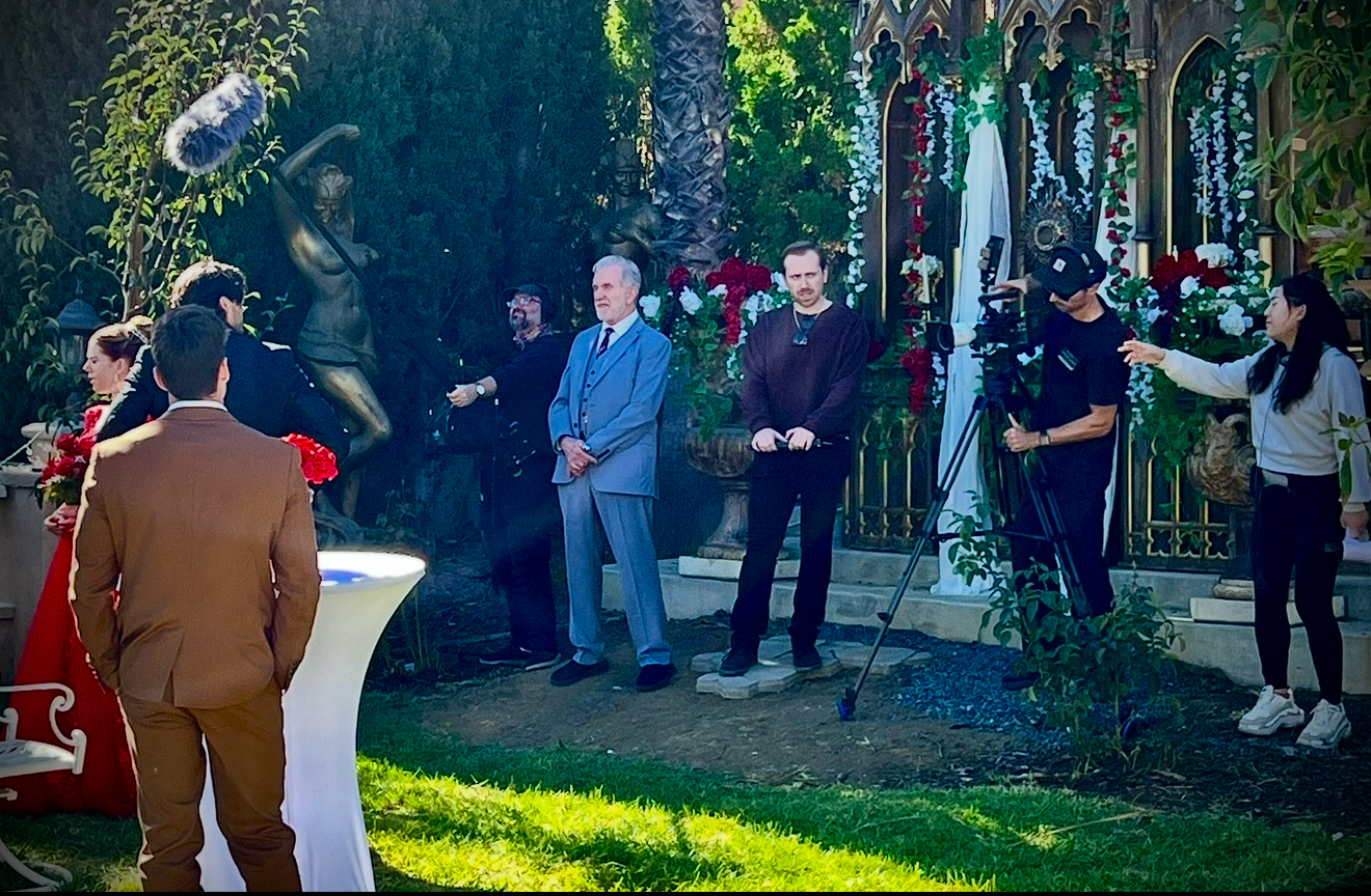 Camera operator filming a production on the gothic garden set at Universal Sanctuary Church