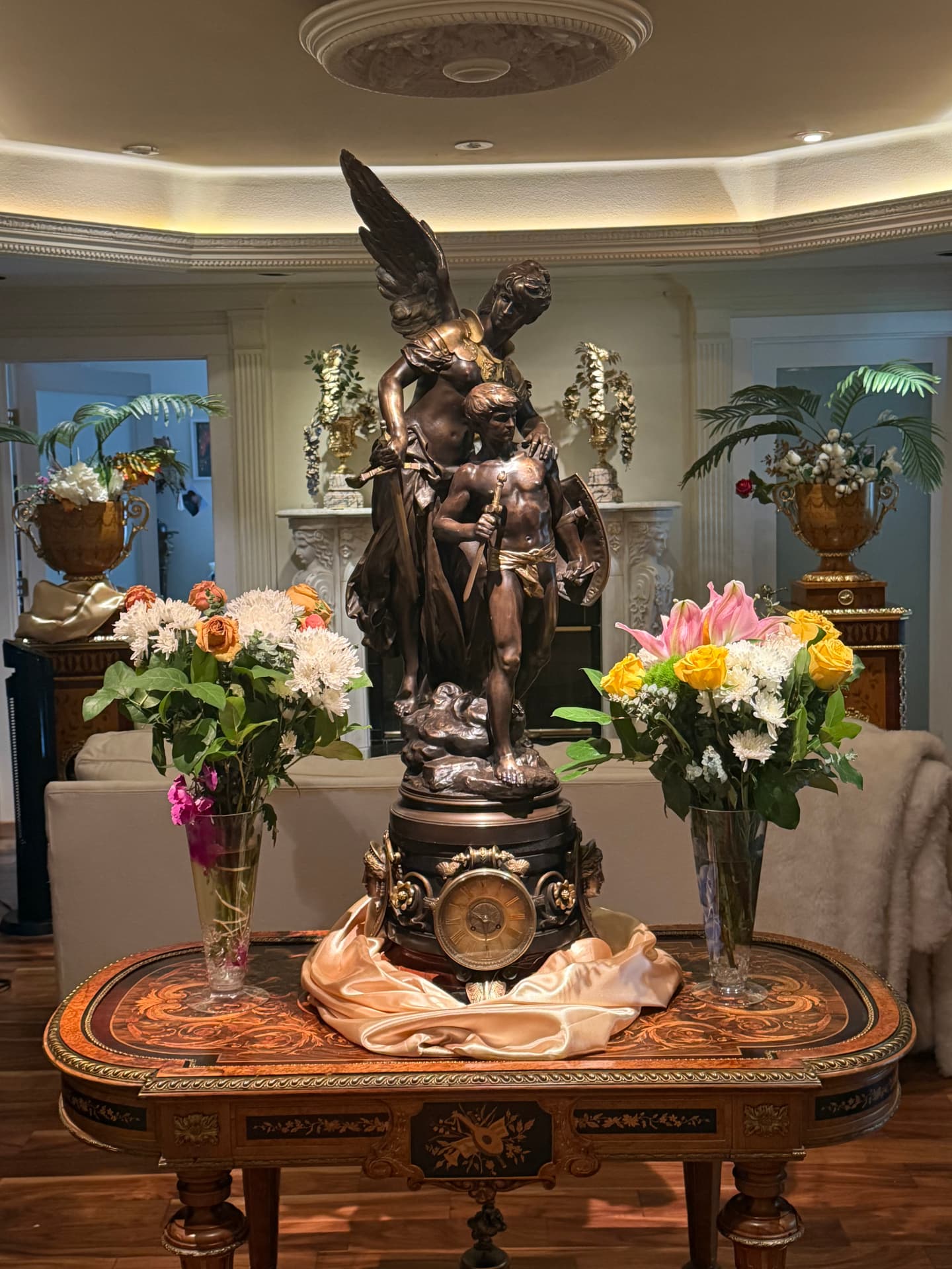 Detailed view of a bronze angel sculpture and flowers at Universal Sanctuary Church