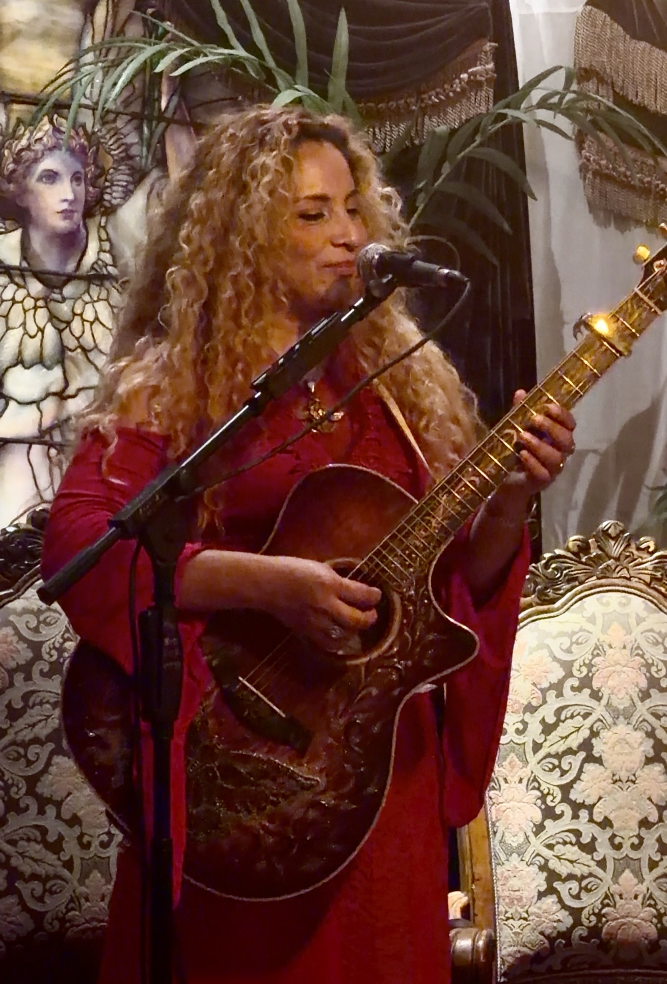 Musician playing guitar and singing at a Universal Sanctuary Church gathering